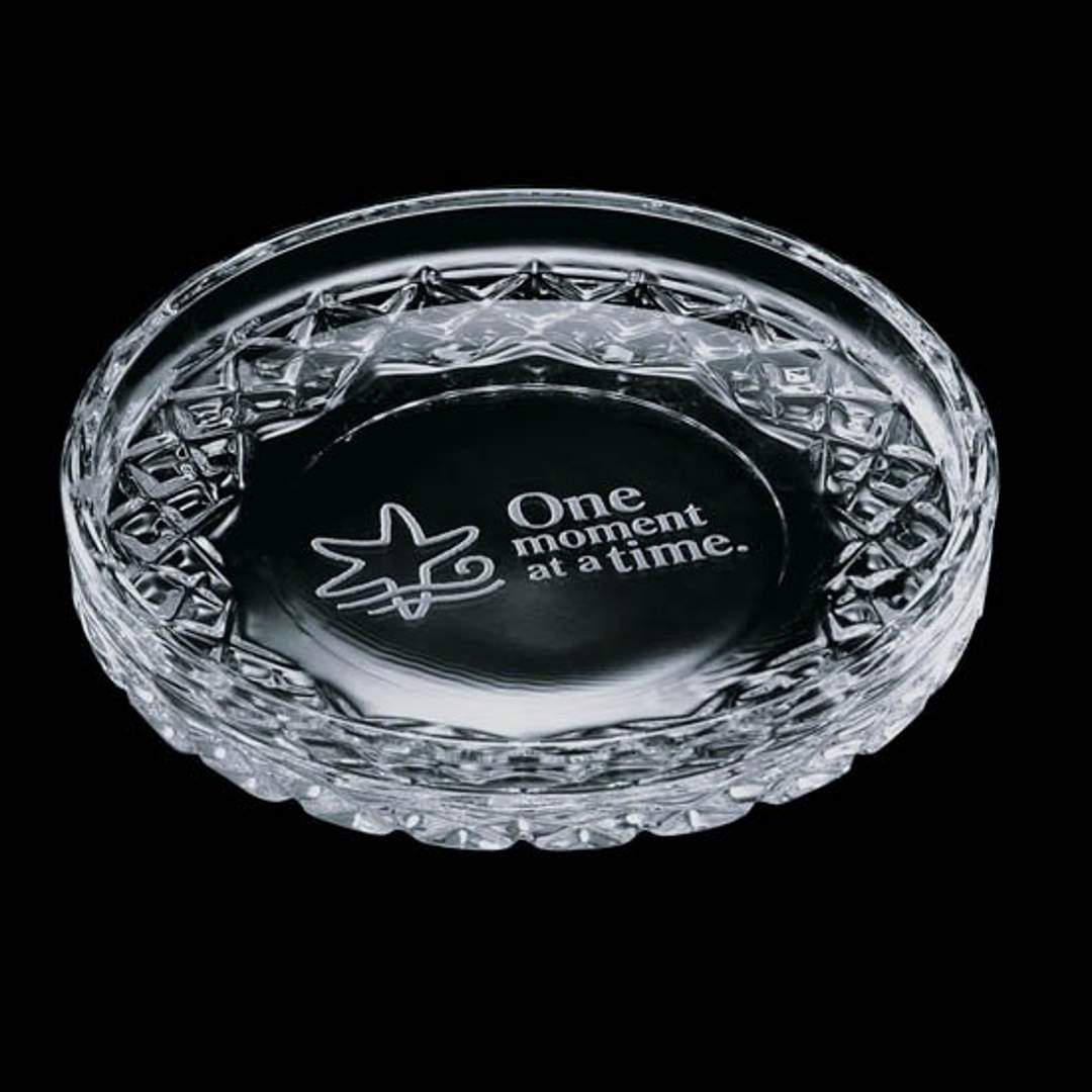 Crystal ashtray with text and star design on a black background