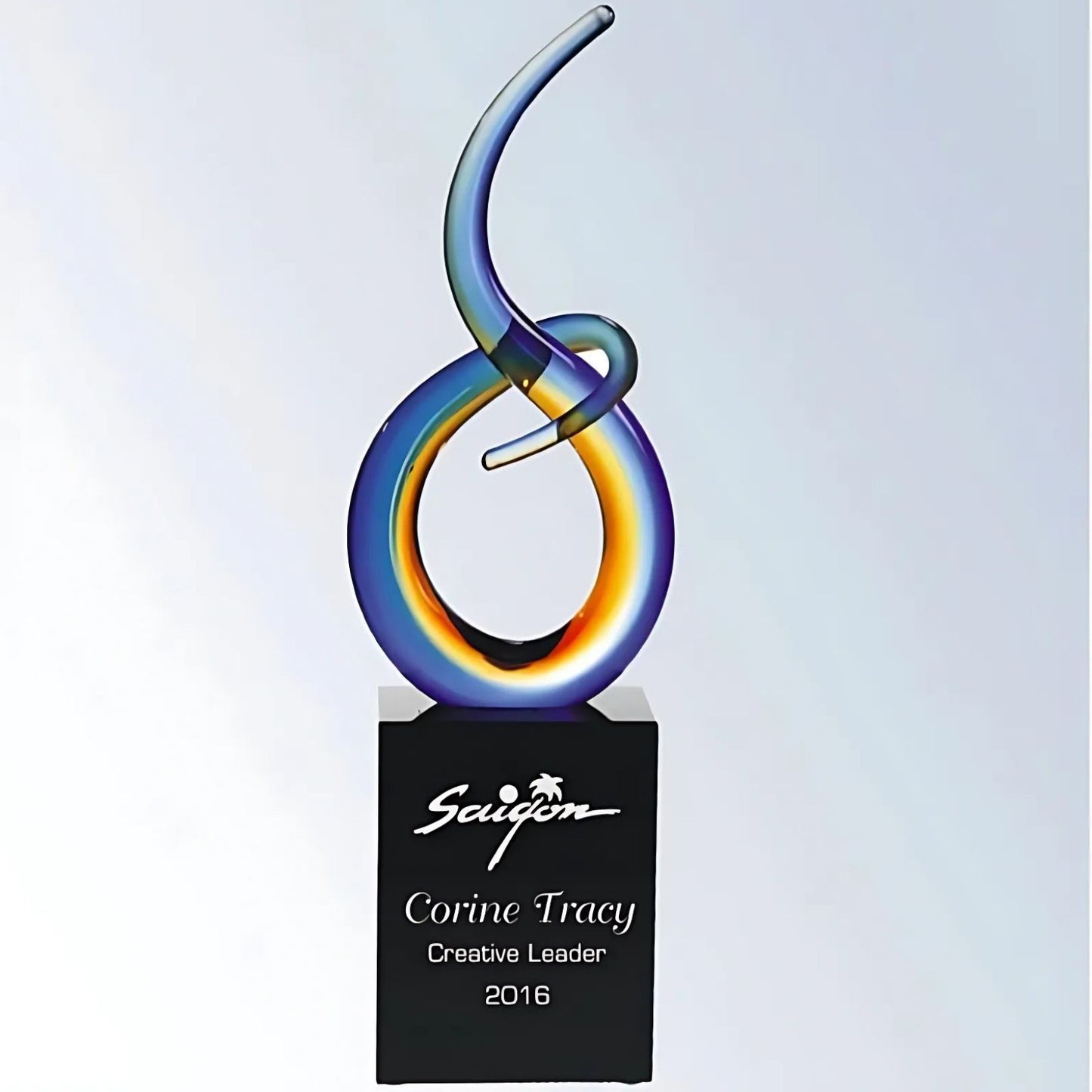 blue and yellow free form art glass award on black base