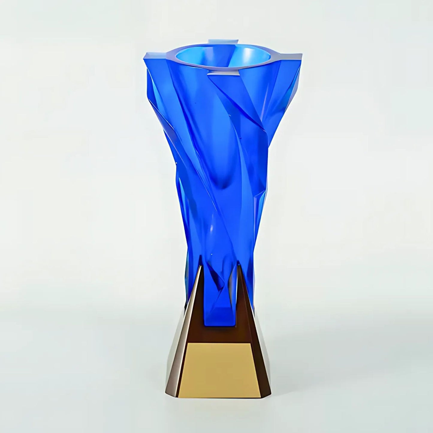 Blue glass vase with gold base on a white background