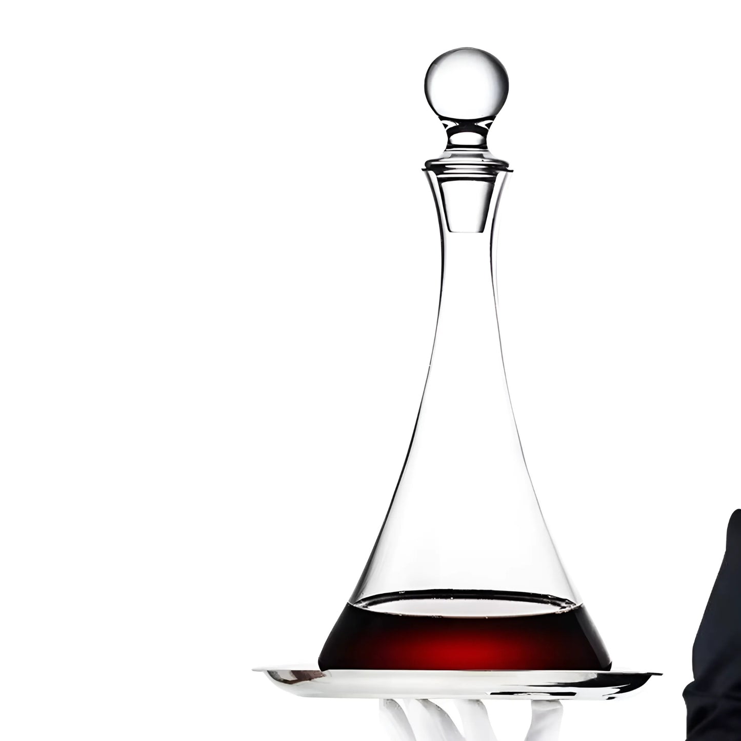 Clear glass wine decanter with red wine on a white background