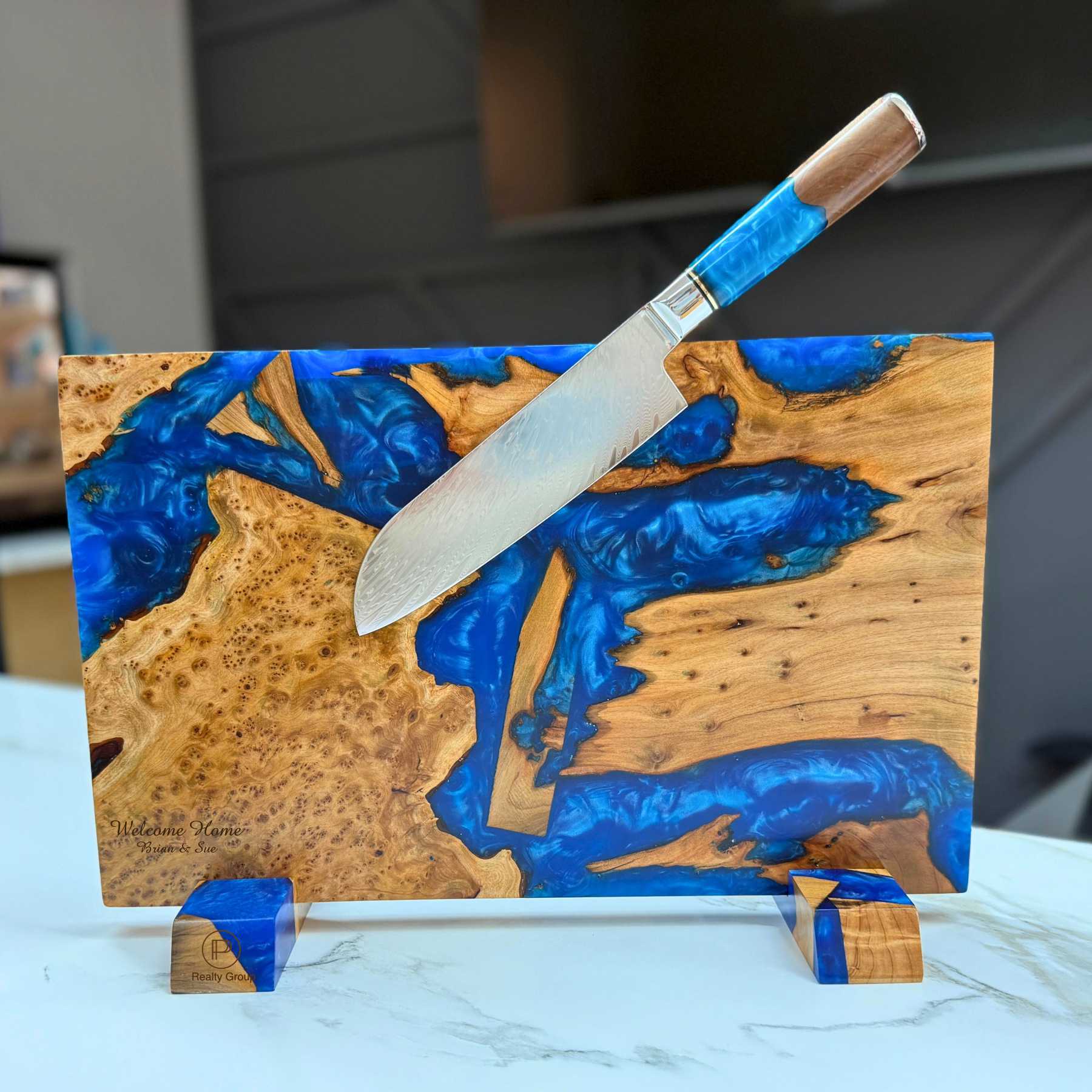 engraved wooden cutting board with artistic blue inlay with knife