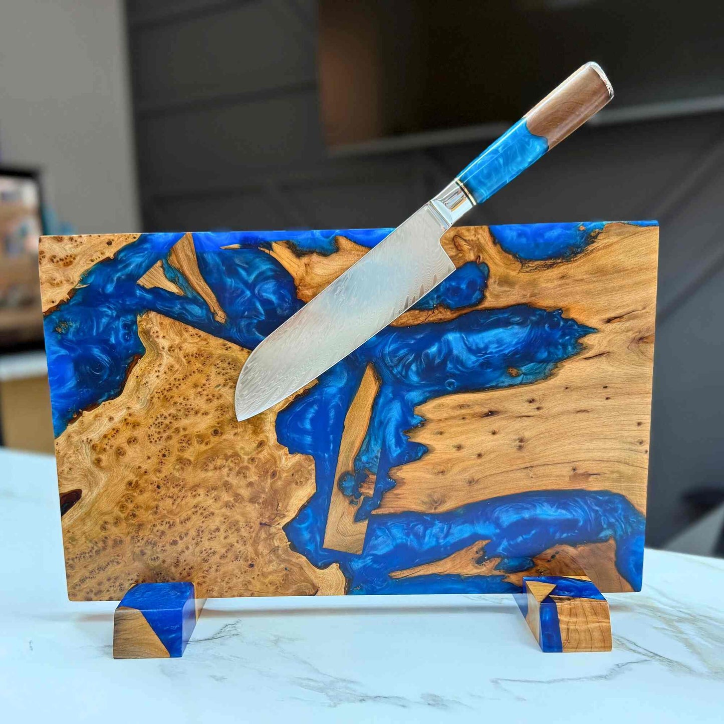 wooden cutting board with artistic blue inlay with knife