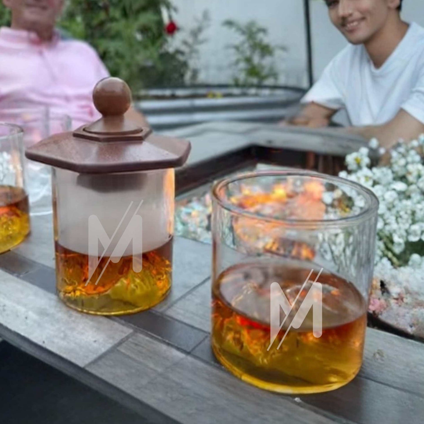 two whiskey glasses with smoker kit in back yard
