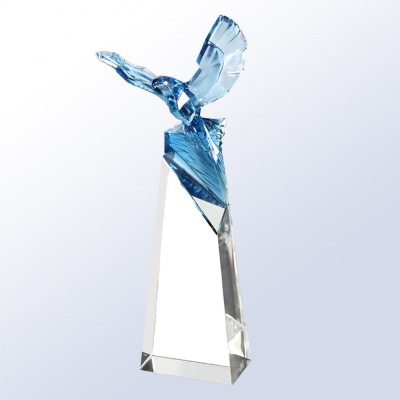 Crystal sculpture of a bird on a white background