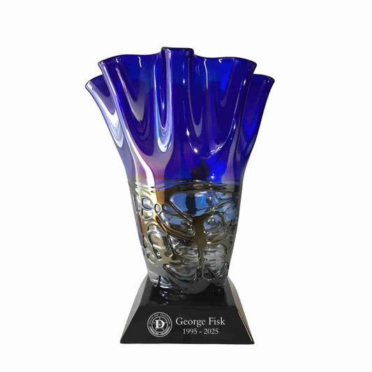 Blue art glass vase on black base with silver fill text