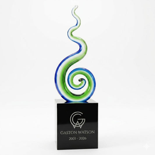 Decorative glass award with a black base featuring 'Gaston Watson' engraving on a white background