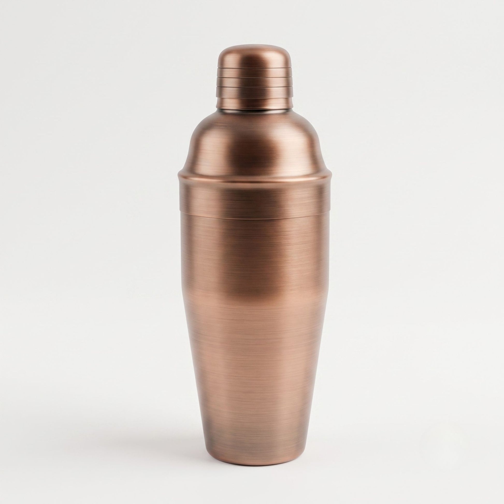 A brushed copper cocktail shaker with a matching lid, shown on a clean white background.