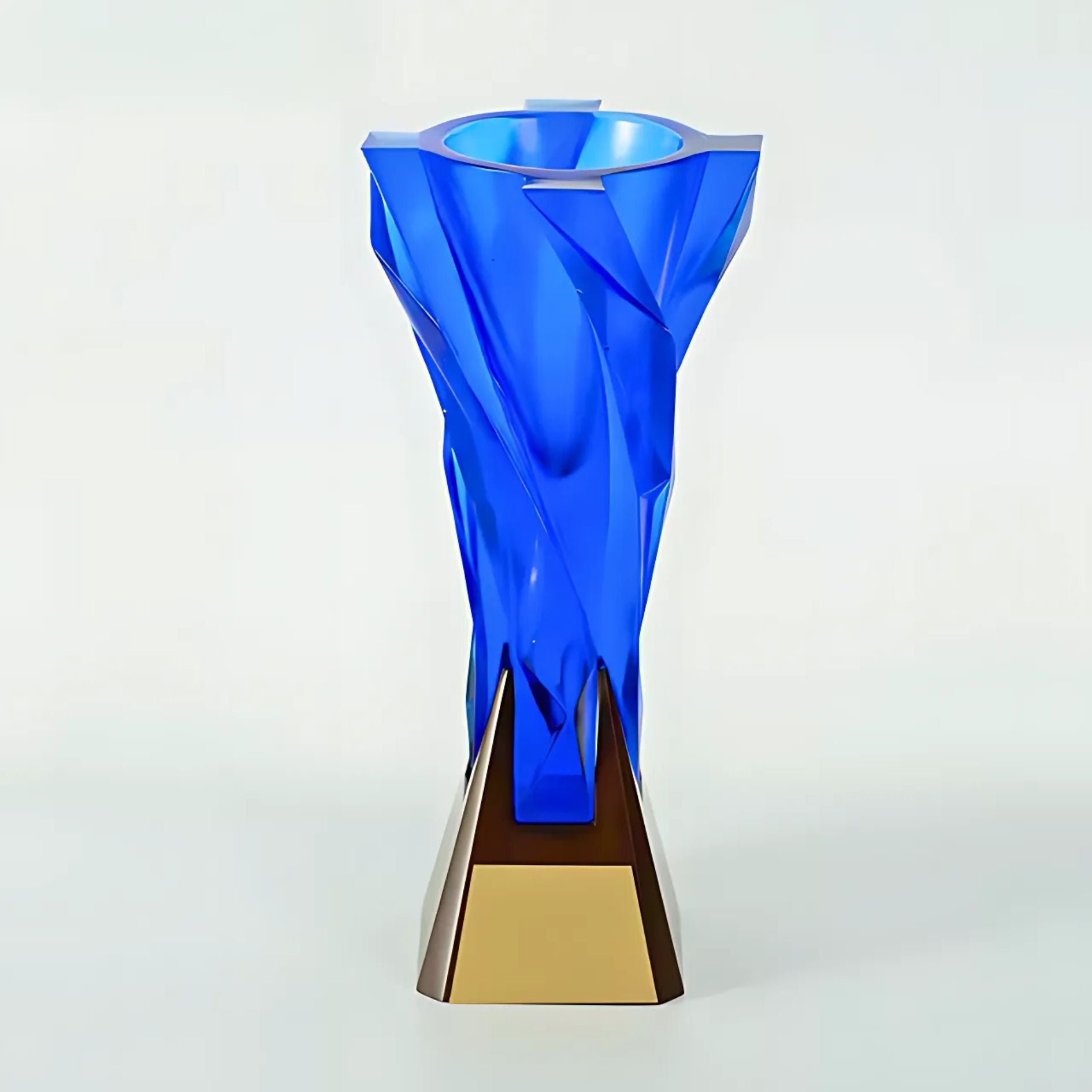 Blue glass vase with gold base on a white background
