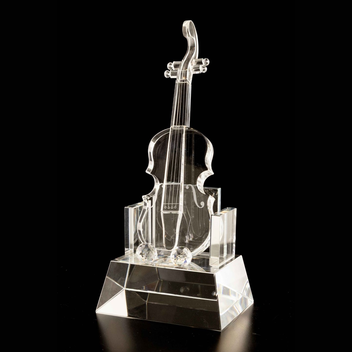 Crystal violin sculpture on a black background
