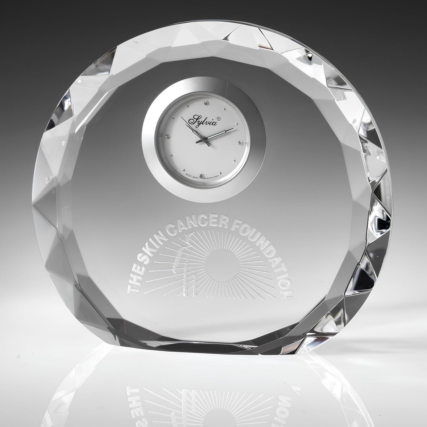 engraved crystal clock on gray background

