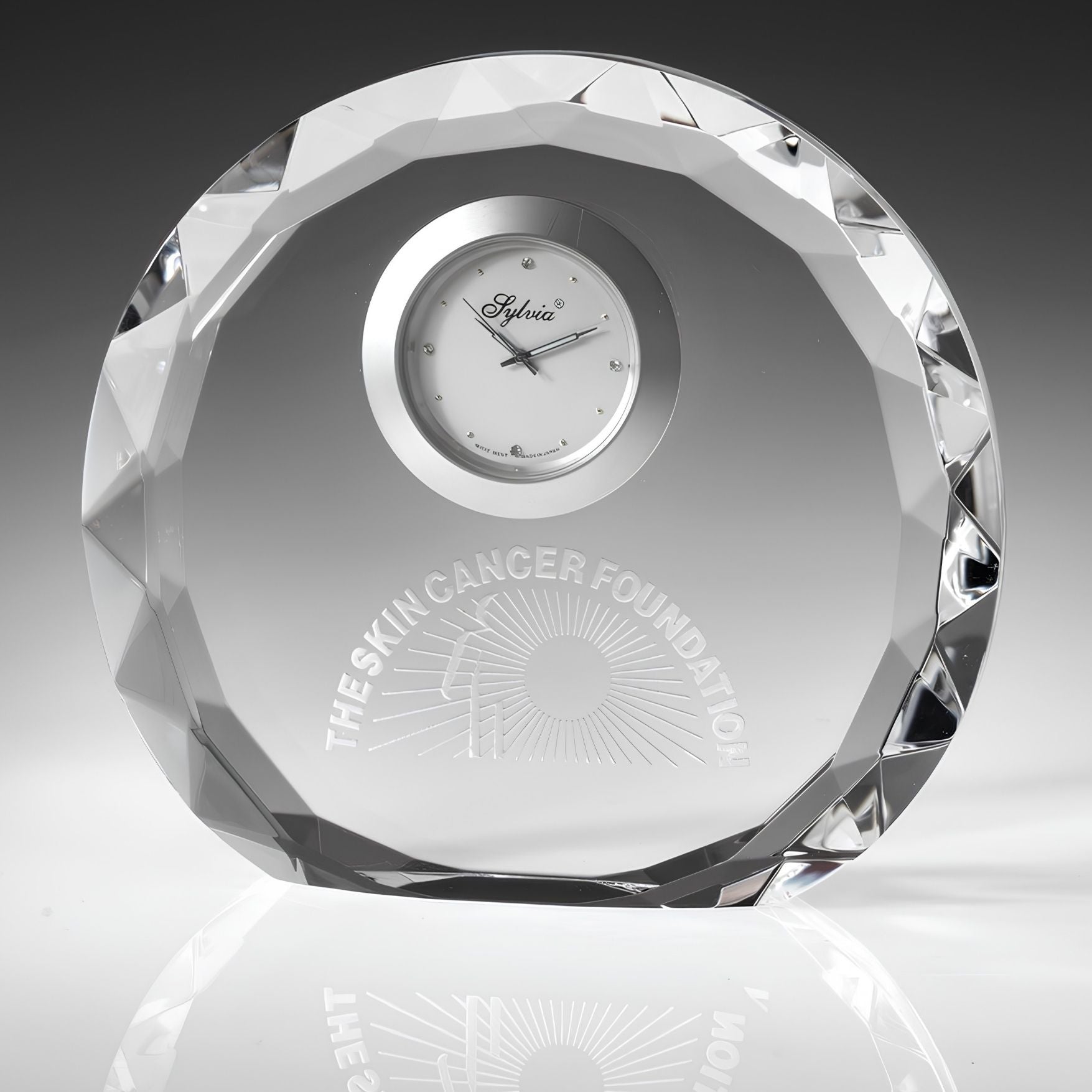 engraved crystal clock on gray background
