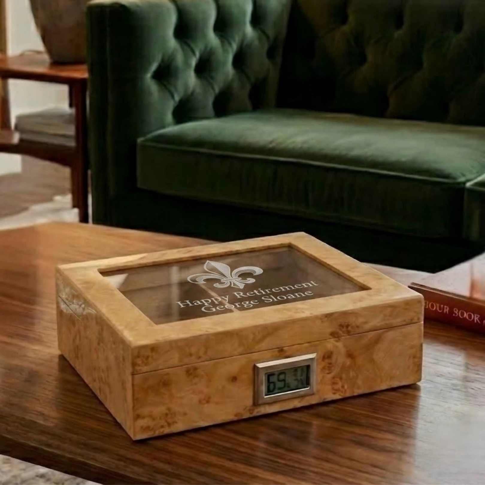 Wooden humidor with digital thermometer on a wooden table, green velvet chair in the background