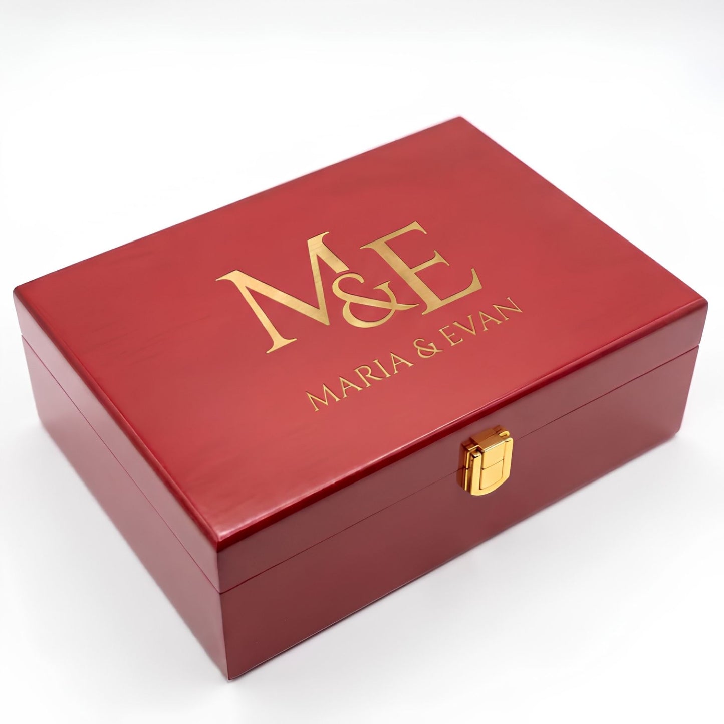 A personalized red wooden keepsake box with gold foil lettering reading 'M&E MARIA & EVAN' on the lid and a small gold latch on the front, shown on a white background.