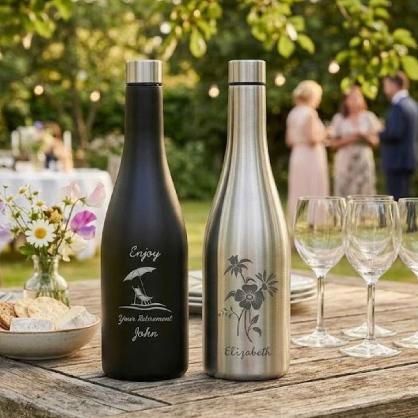stainless steel wine bottle flasks on table with wine glasses in a garden setting
