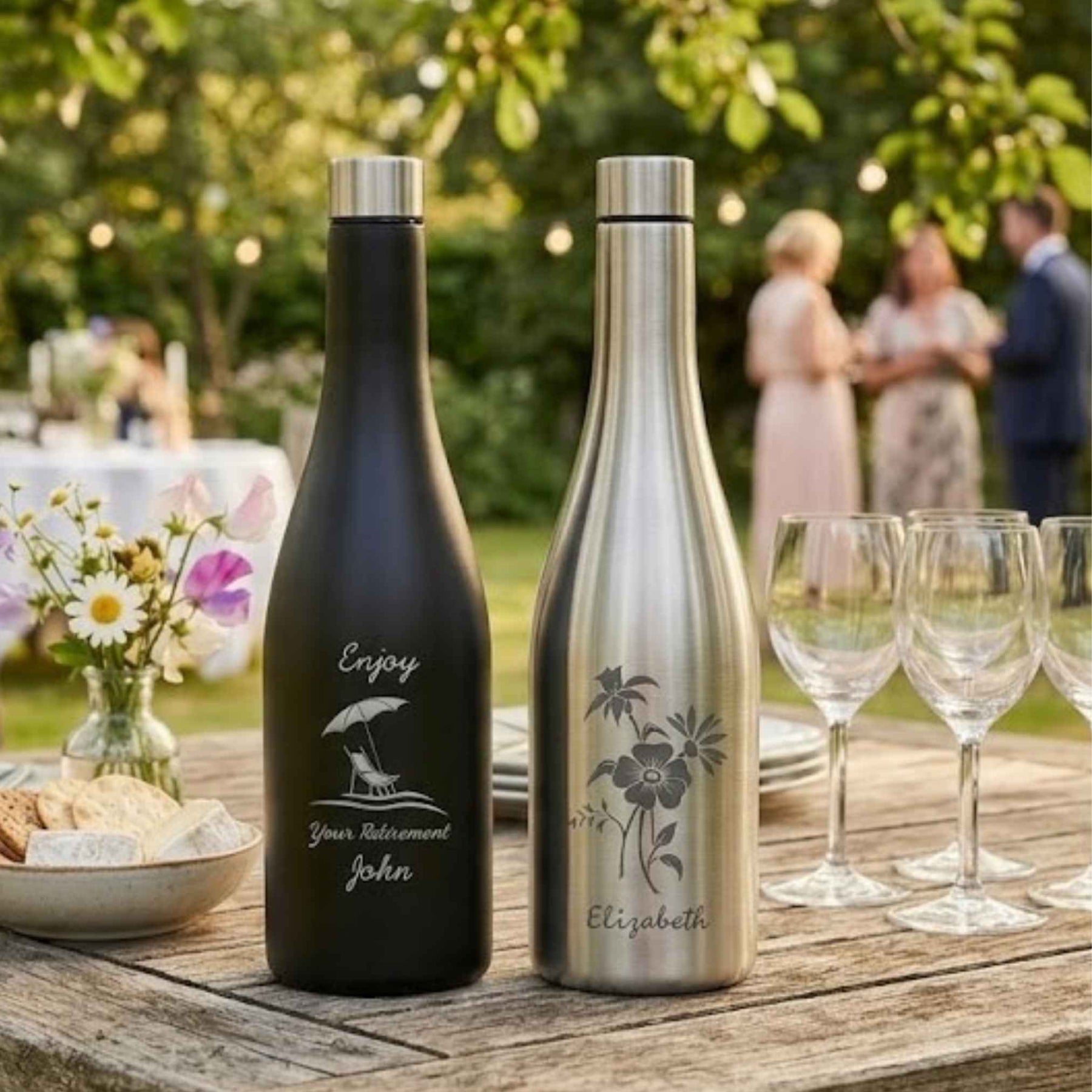 stainless steel wine bottle flasks on table with wine glasses in a garden setting