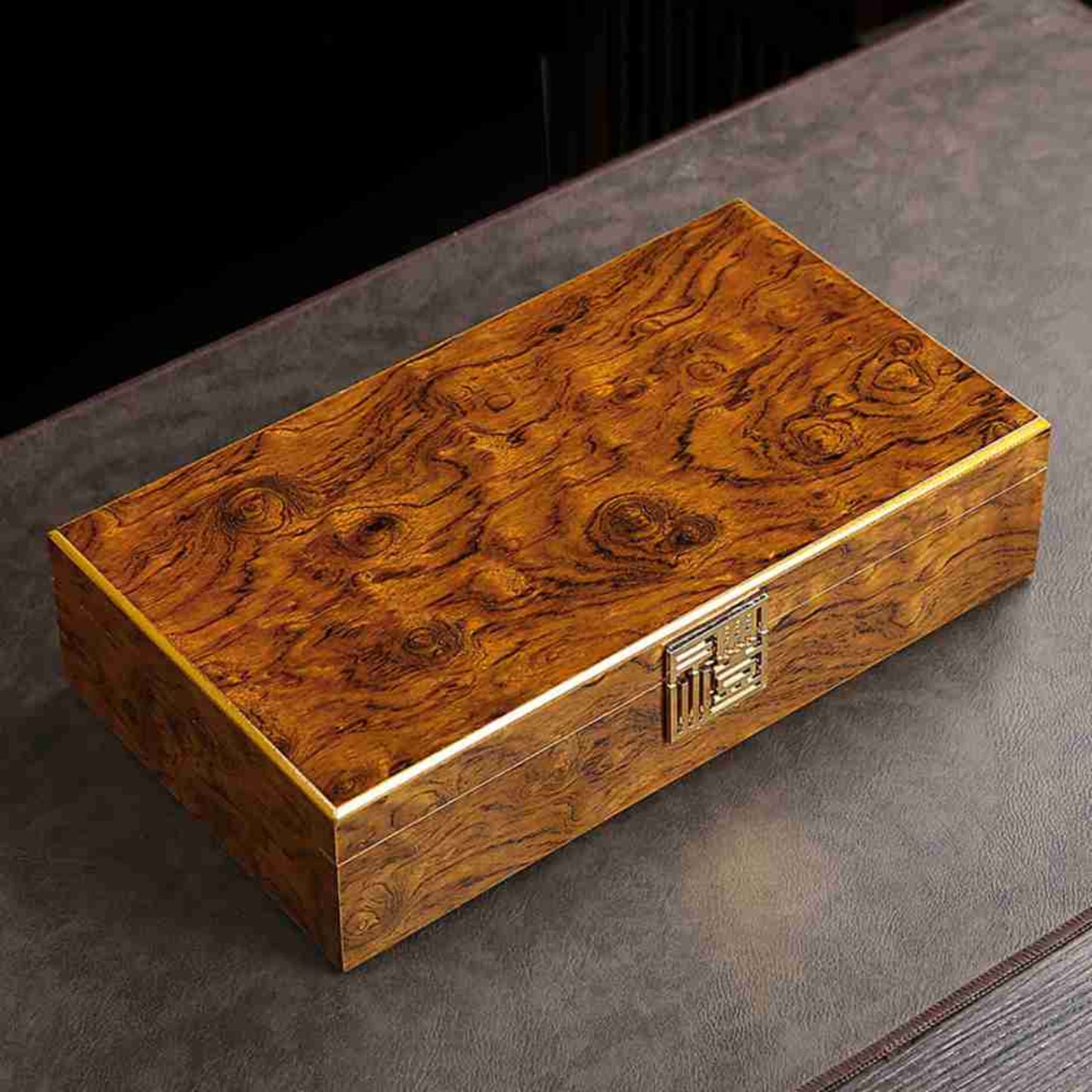 wooden teabox with gold clasp black background
