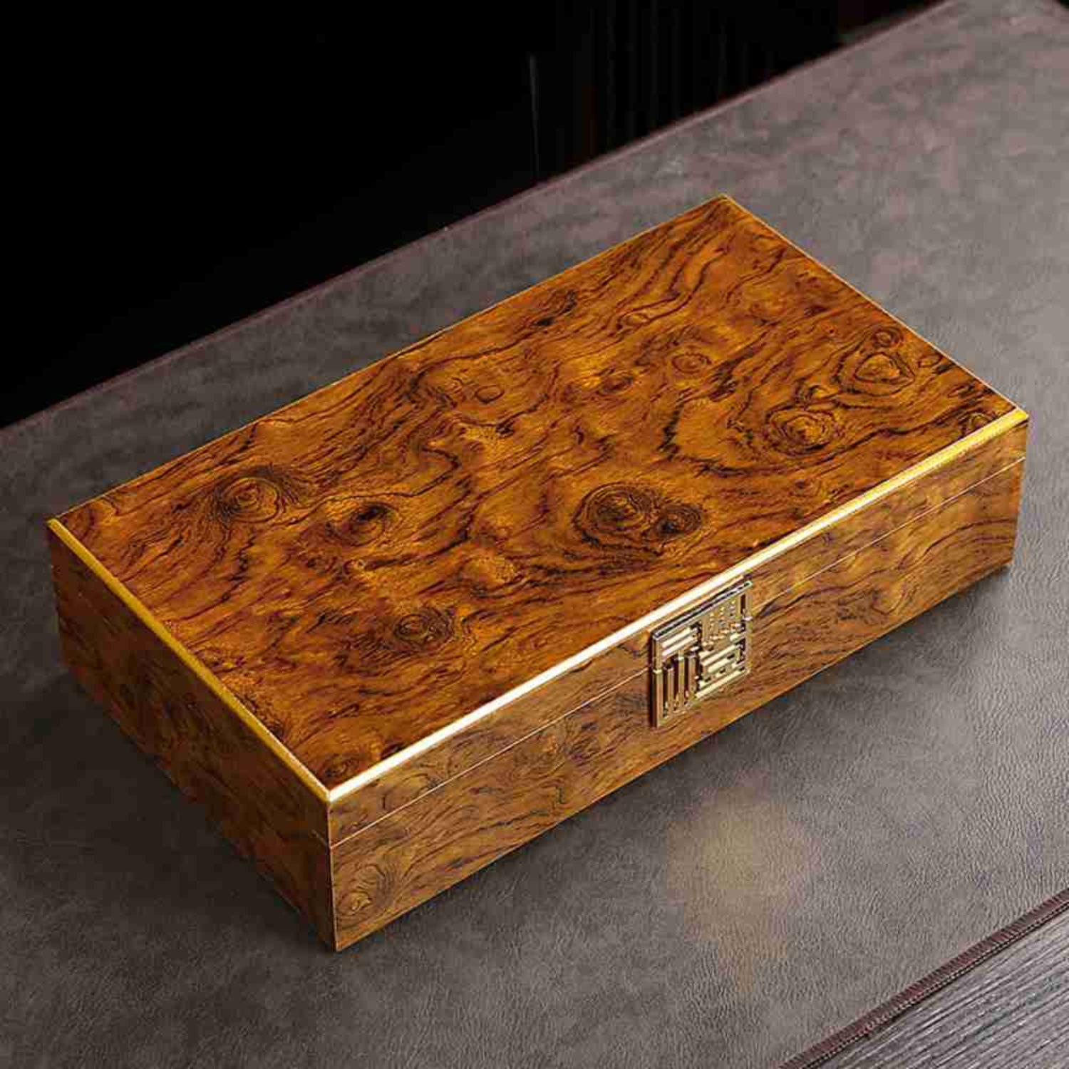 wooden teabox with gold clasp black background
