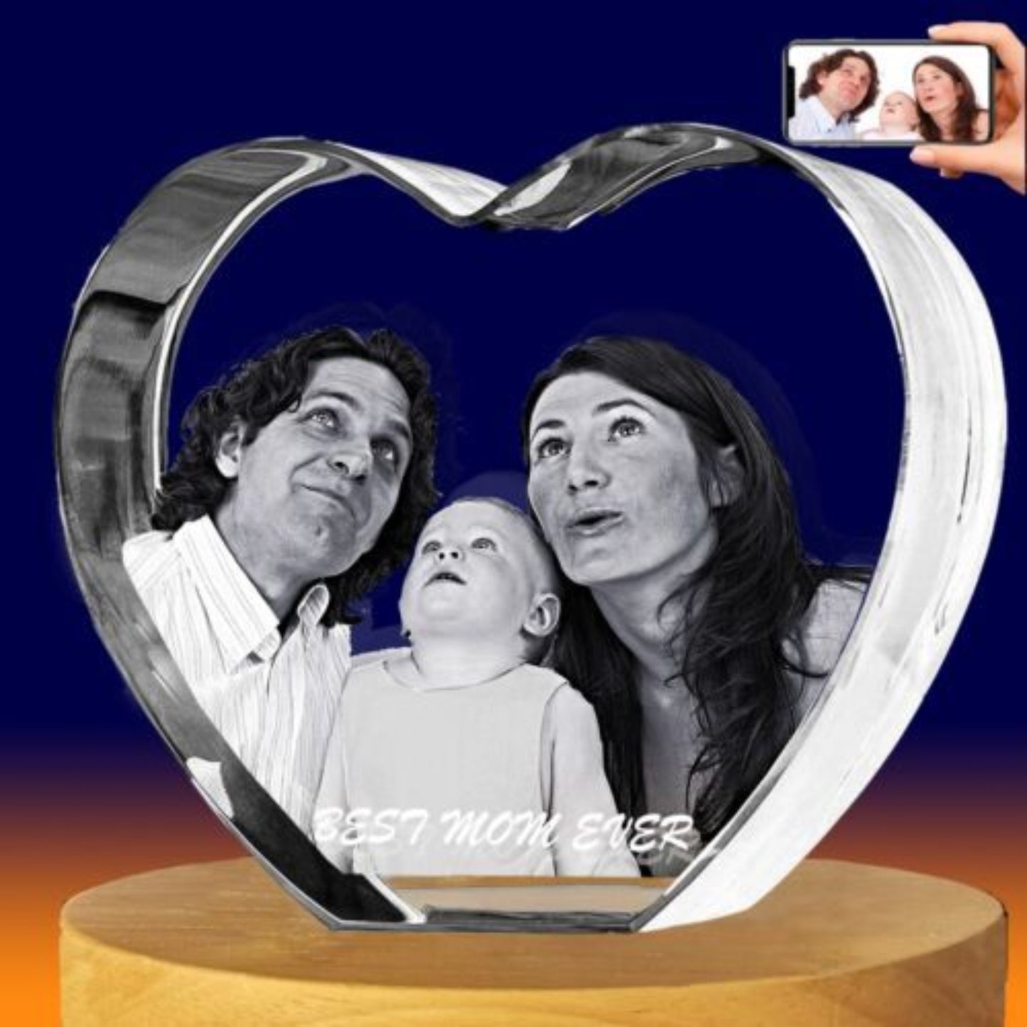A heart-shaped clear crystal keepsake photo plaque displayed on a round wooden base, with a black-and-white family portrait printed inside. 
