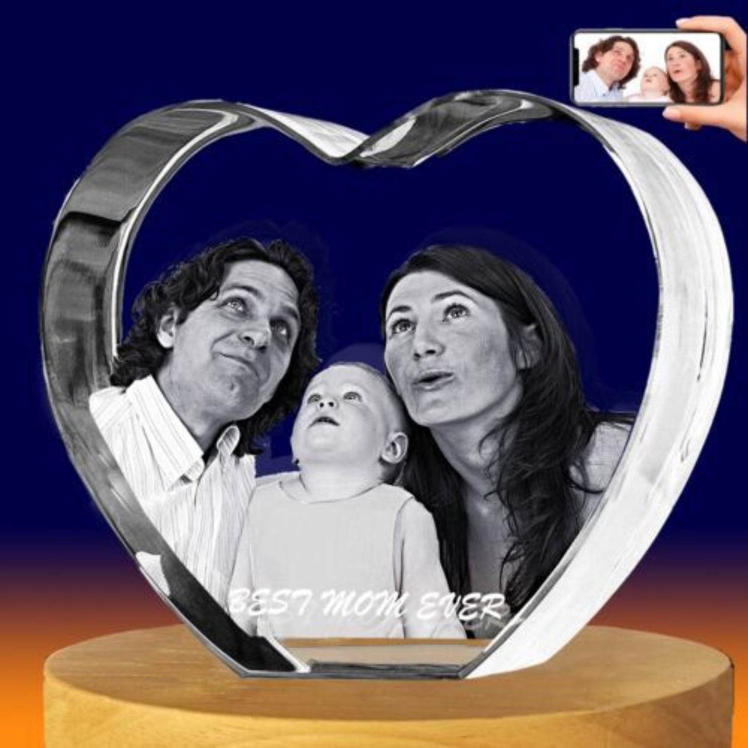 A heart-shaped clear crystal keepsake photo plaque displayed on a round wooden base, with a black-and-white family portrait printed inside. 