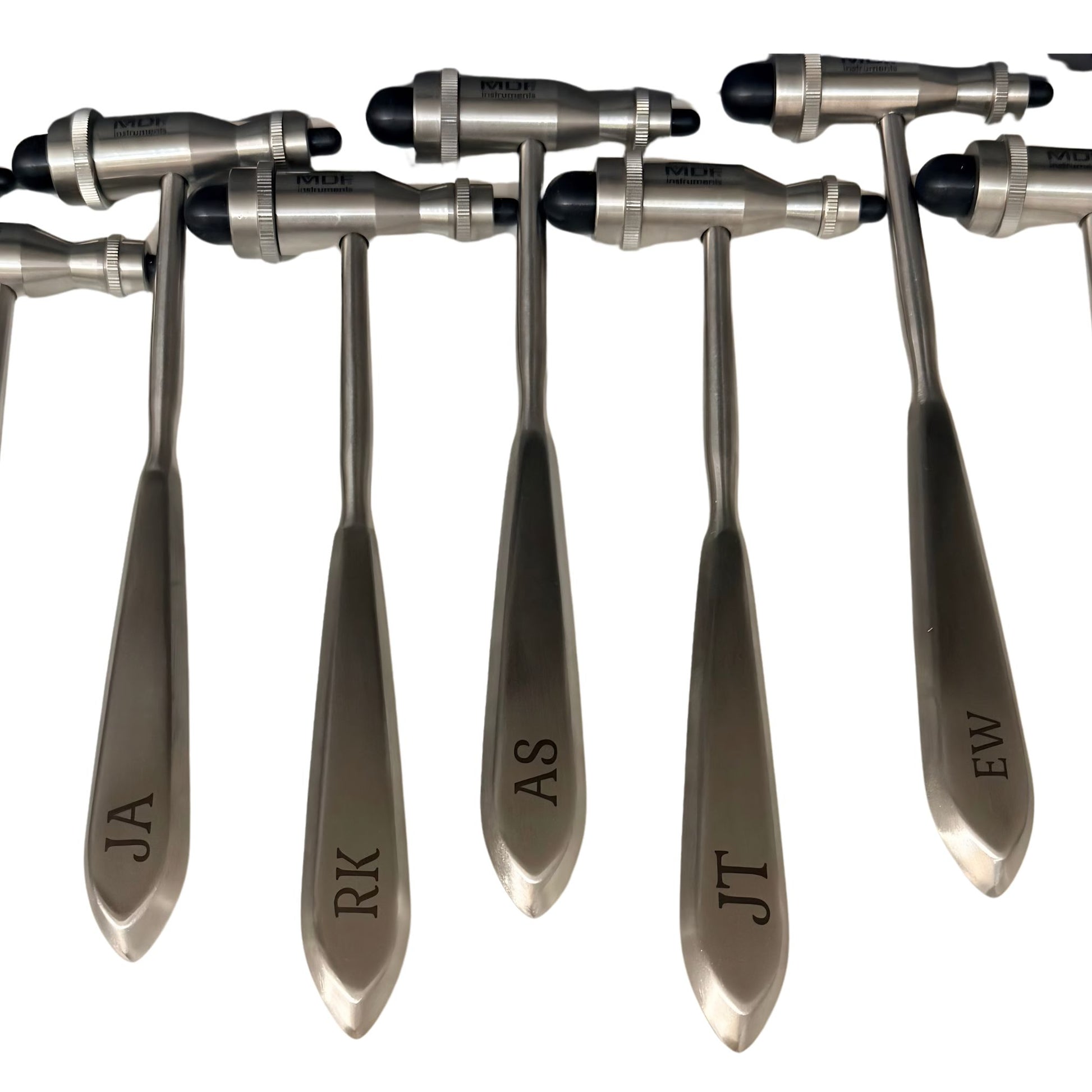 Five stainless steel personalized medical instruments with engraved names (JA, RK, AS, JT, EW) on their handles, arranged in a row against a white background.