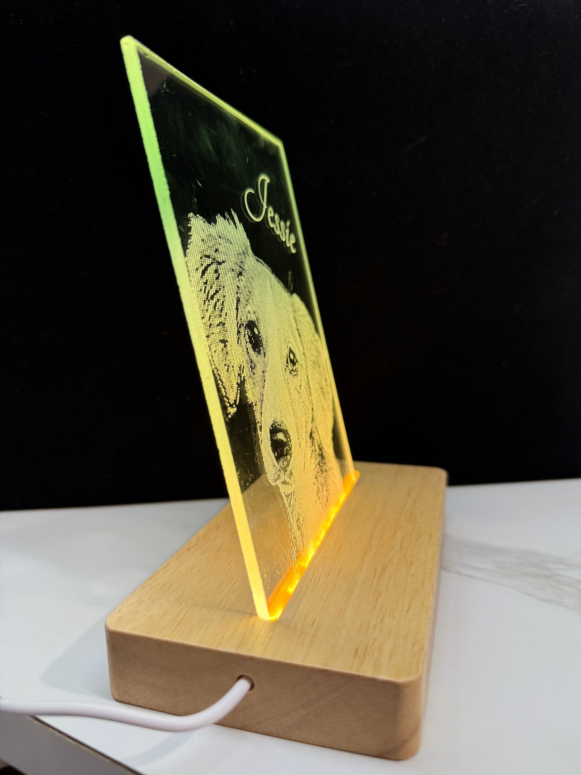 photo with engraved dog's face and name 'Jessie' engraved on glass on a wooden stand